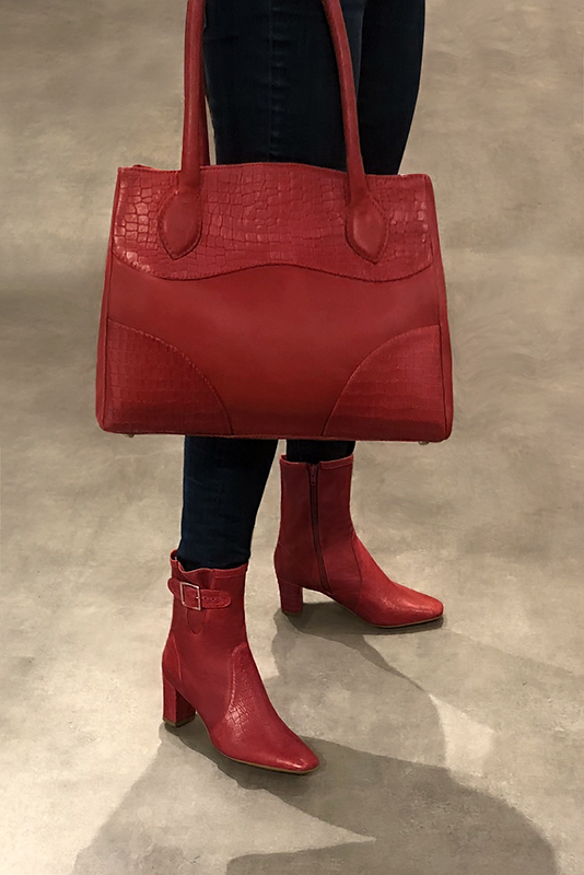 Scarlet red women's ankle boots with buckles on the sides. Square toe. Medium block heels. Worn view - Florence KOOIJMAN